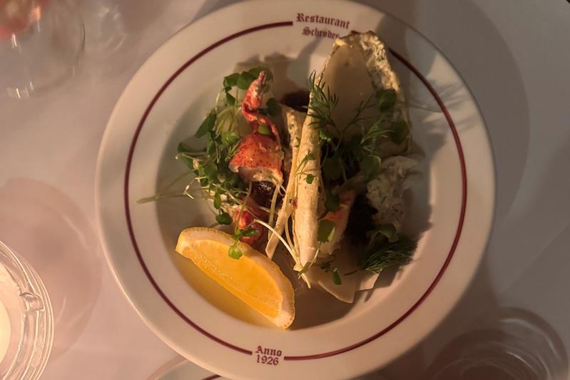 Norwegian seafood dish with herring served on a white plate.