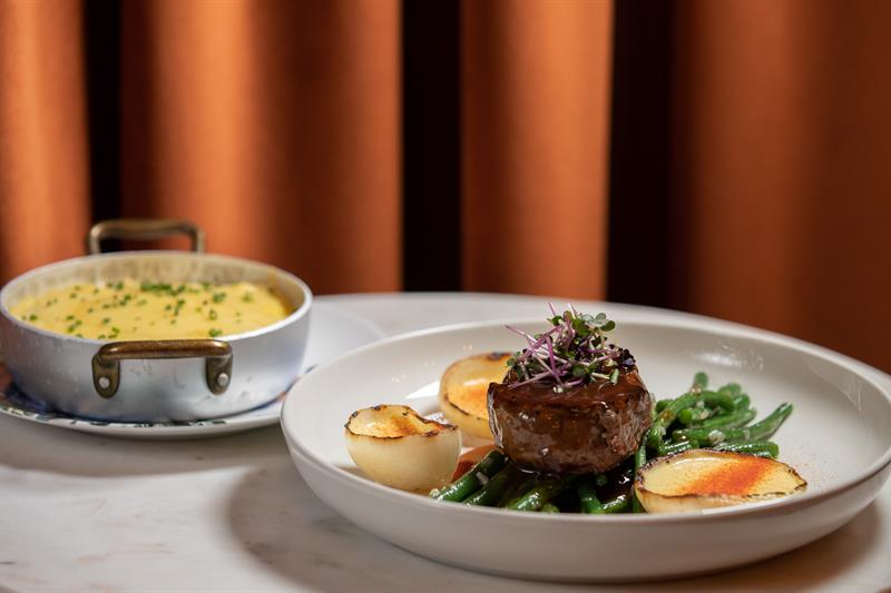 Detail photo of meat dish and side dish.