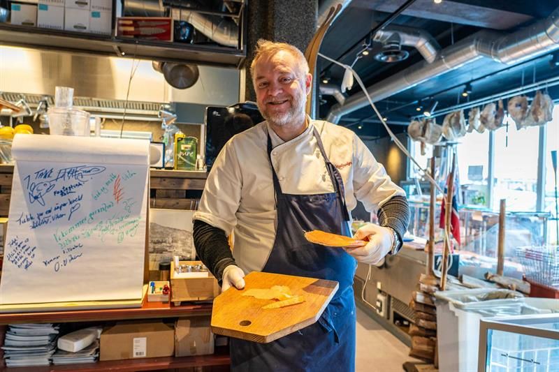 Man with chopping board and dried meat