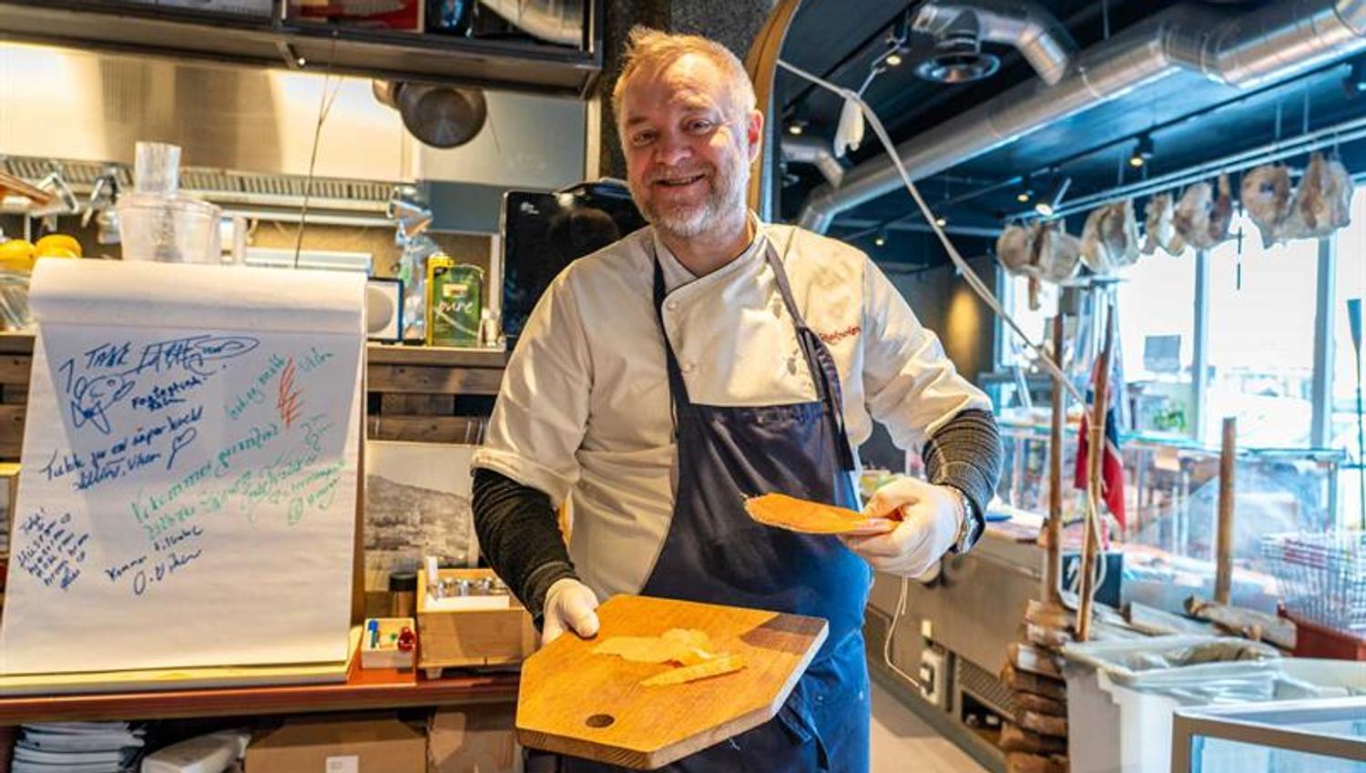Man with chopping board and dried meat