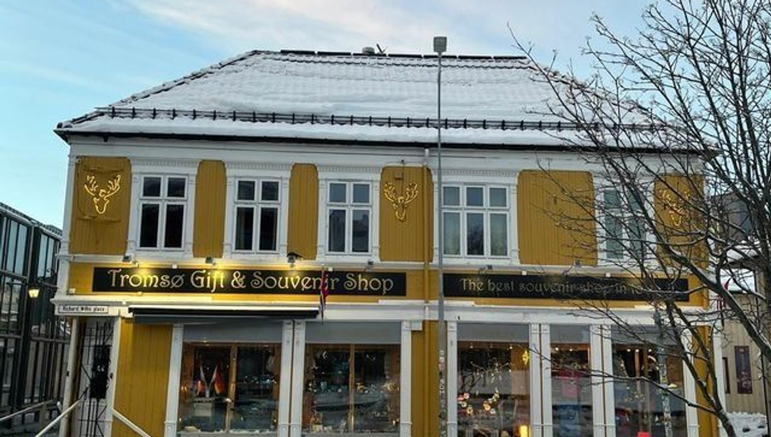 Tromsø Gift & Souvenir Shop surrounded by snow-covered scenery during the winter season.