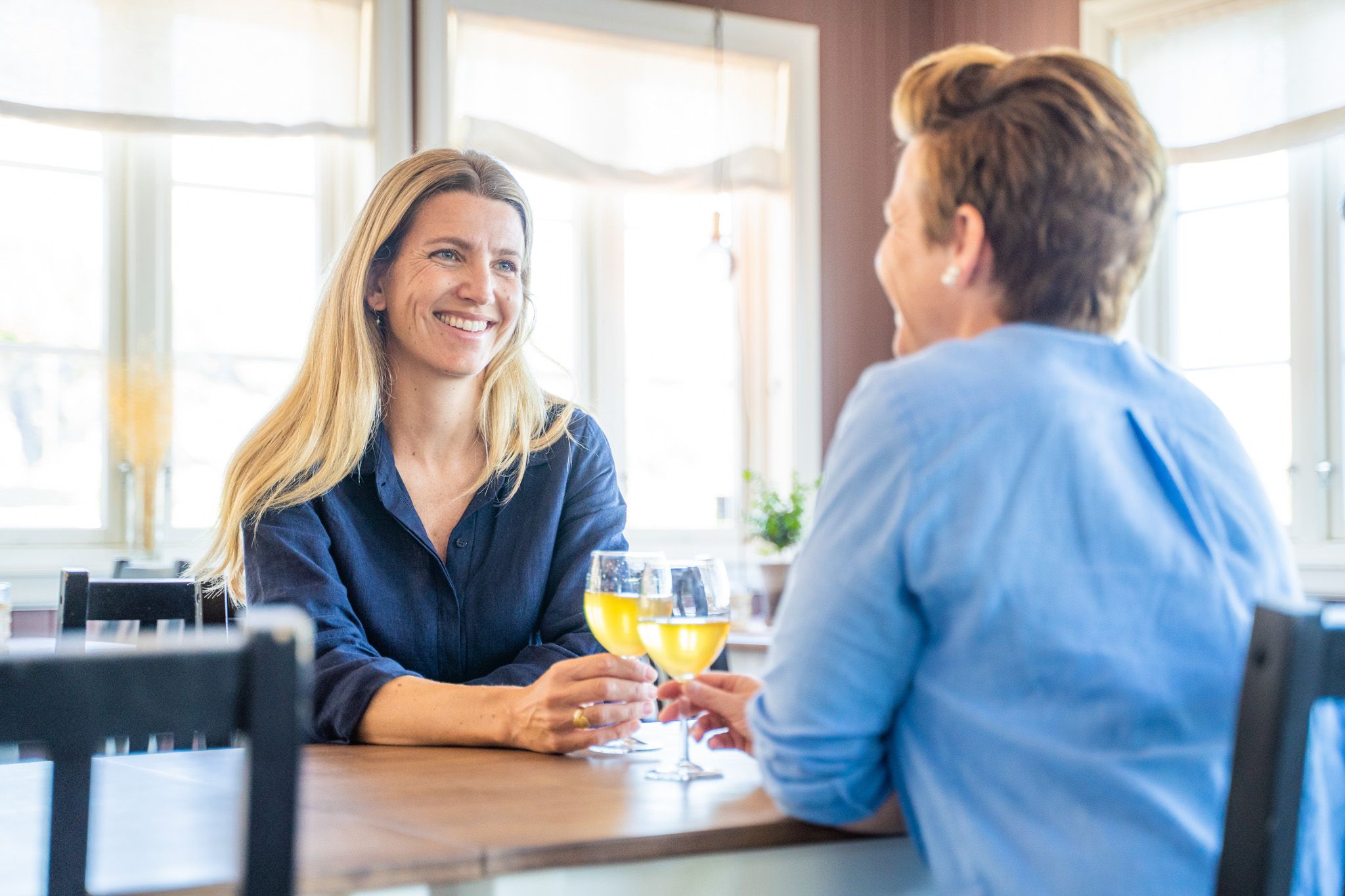 to women enjoying themselfs at a cafe