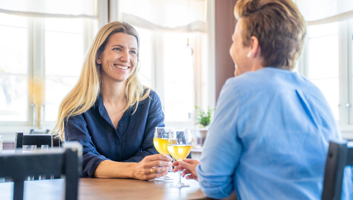 to women enjoying themselfs at a cafe