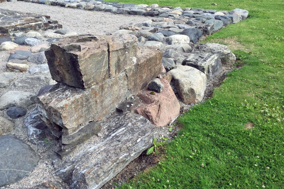 Wall ruins by a lawn.