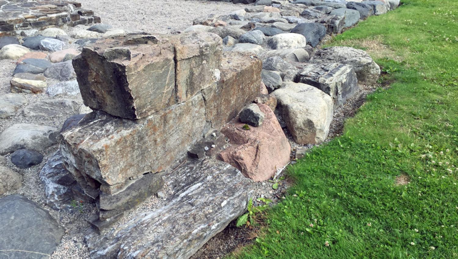 Wall ruins by a lawn.