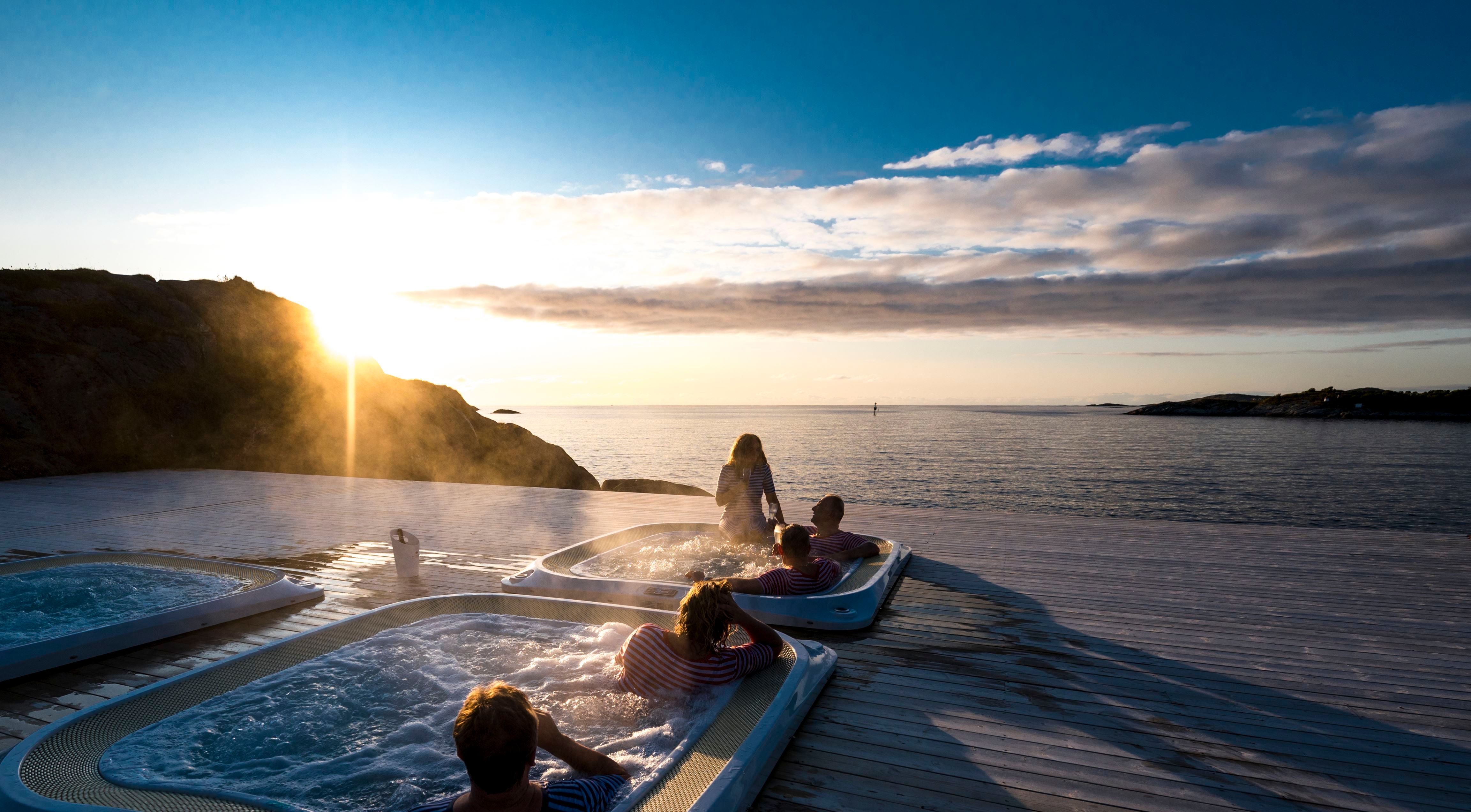 People in a hot tub enjoying the Northern Norwegian evening sun.