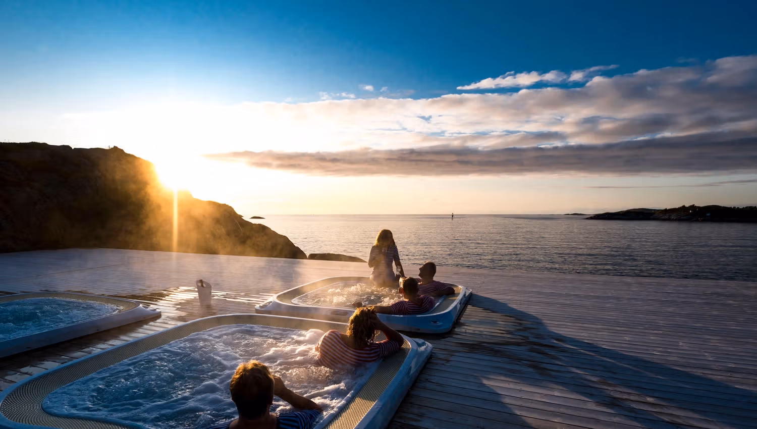 People in a hot tub enjoying the Northern Norwegian evening sun.