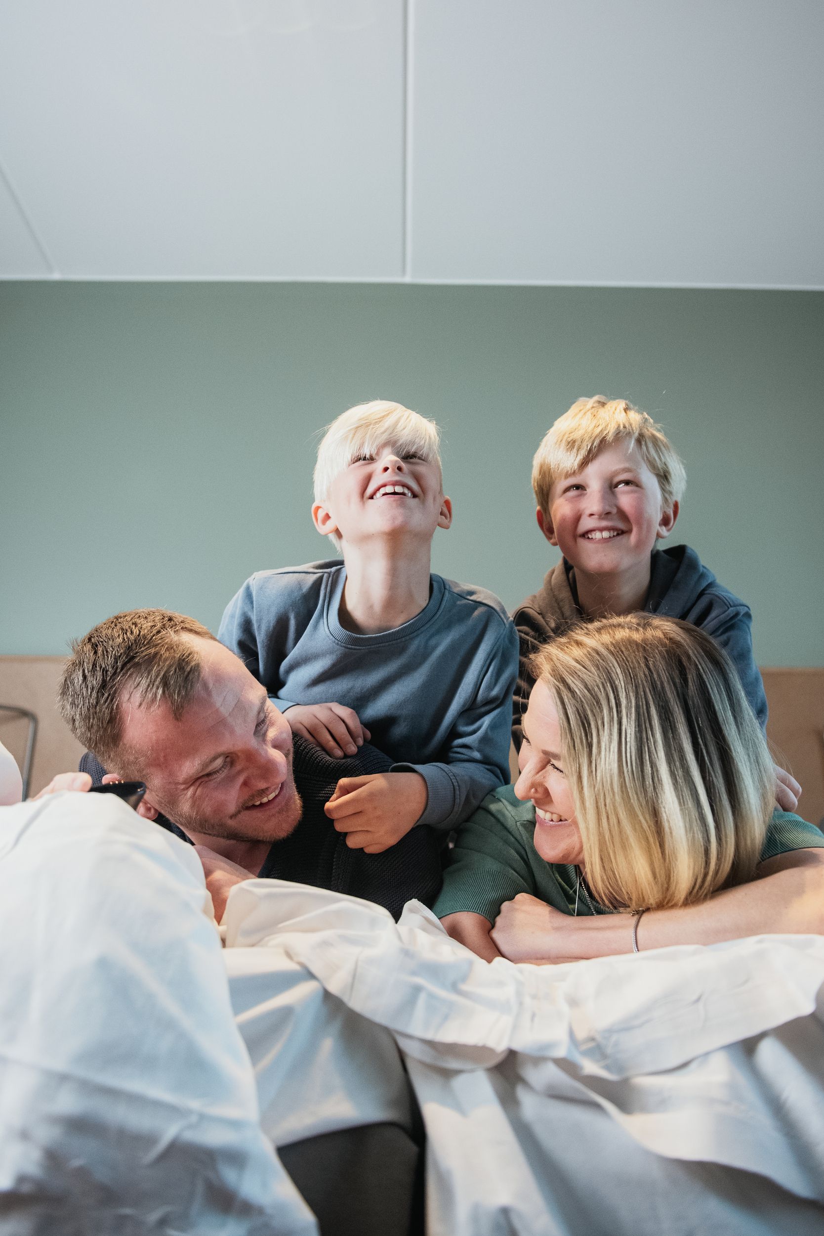 Family in bed laughing