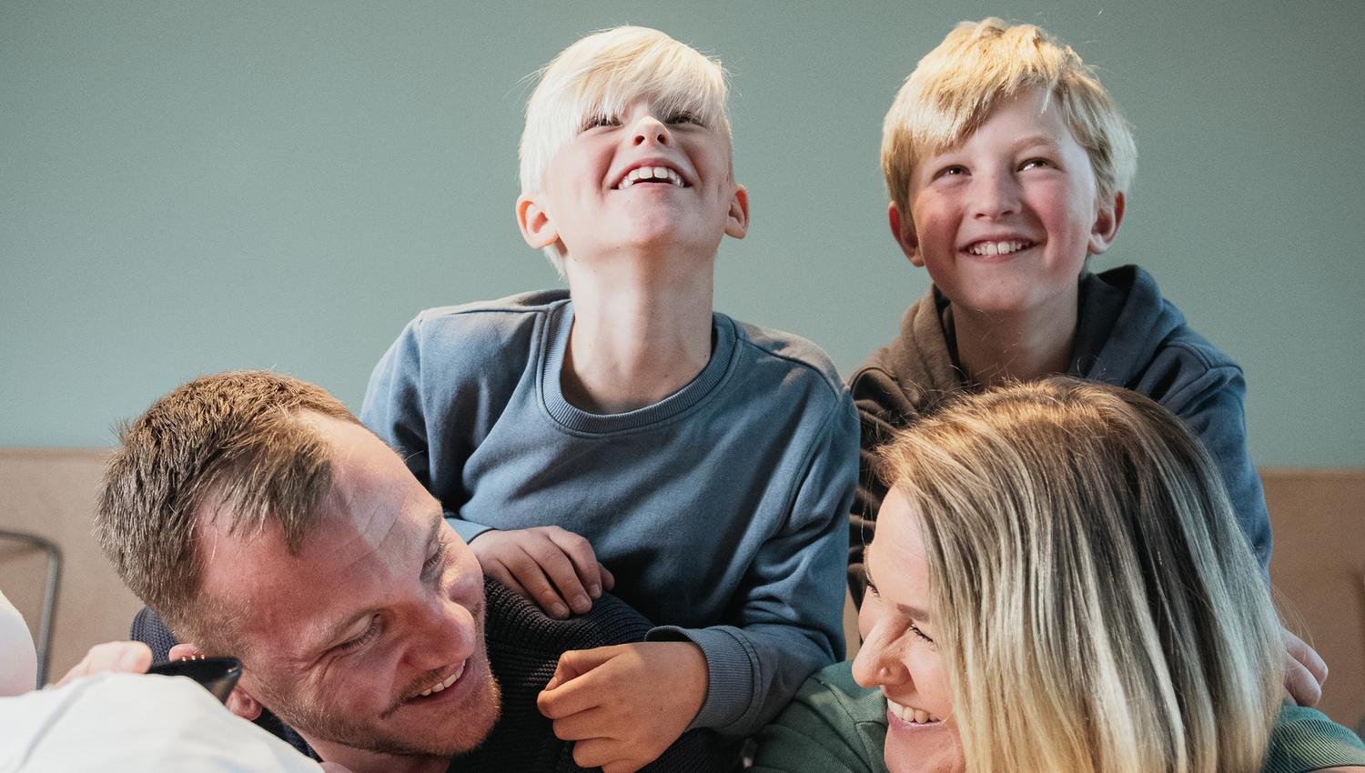 Family in bed laughing