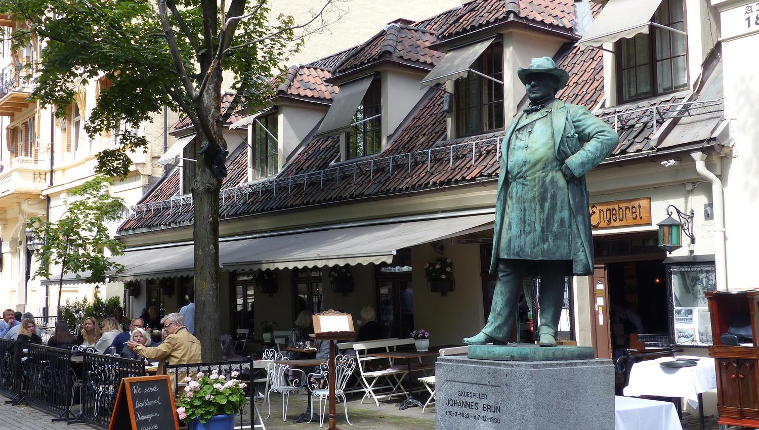Exterior with outdoor seating next to a statue.