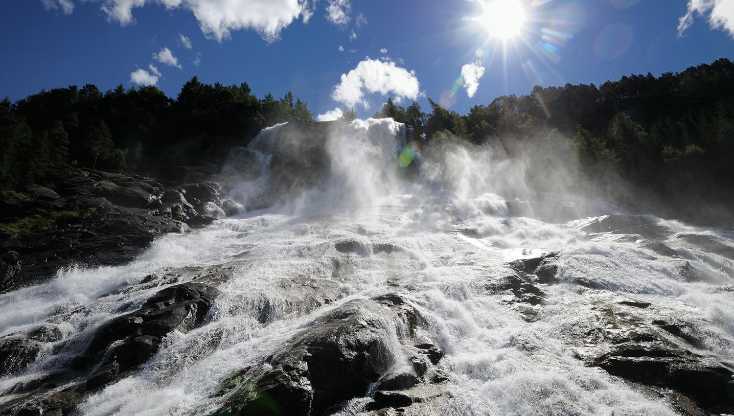 Sunlit Furubergsfossen – A dramatic shot of Furubergsfossen with sunlight breaking through the water, creating a magical atmosphere.