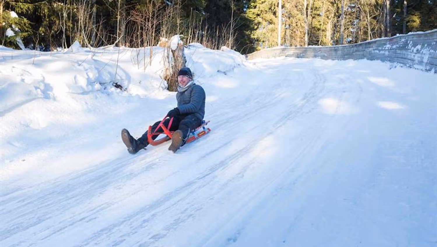 A person sledding down a snow-covered hill.