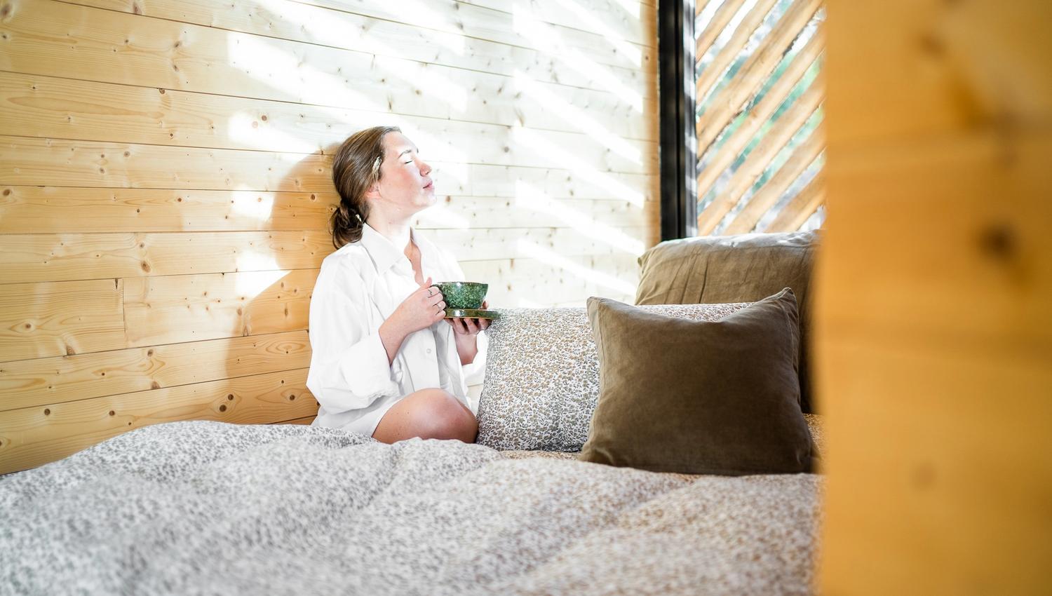 Woman enjoying sun with coffee
