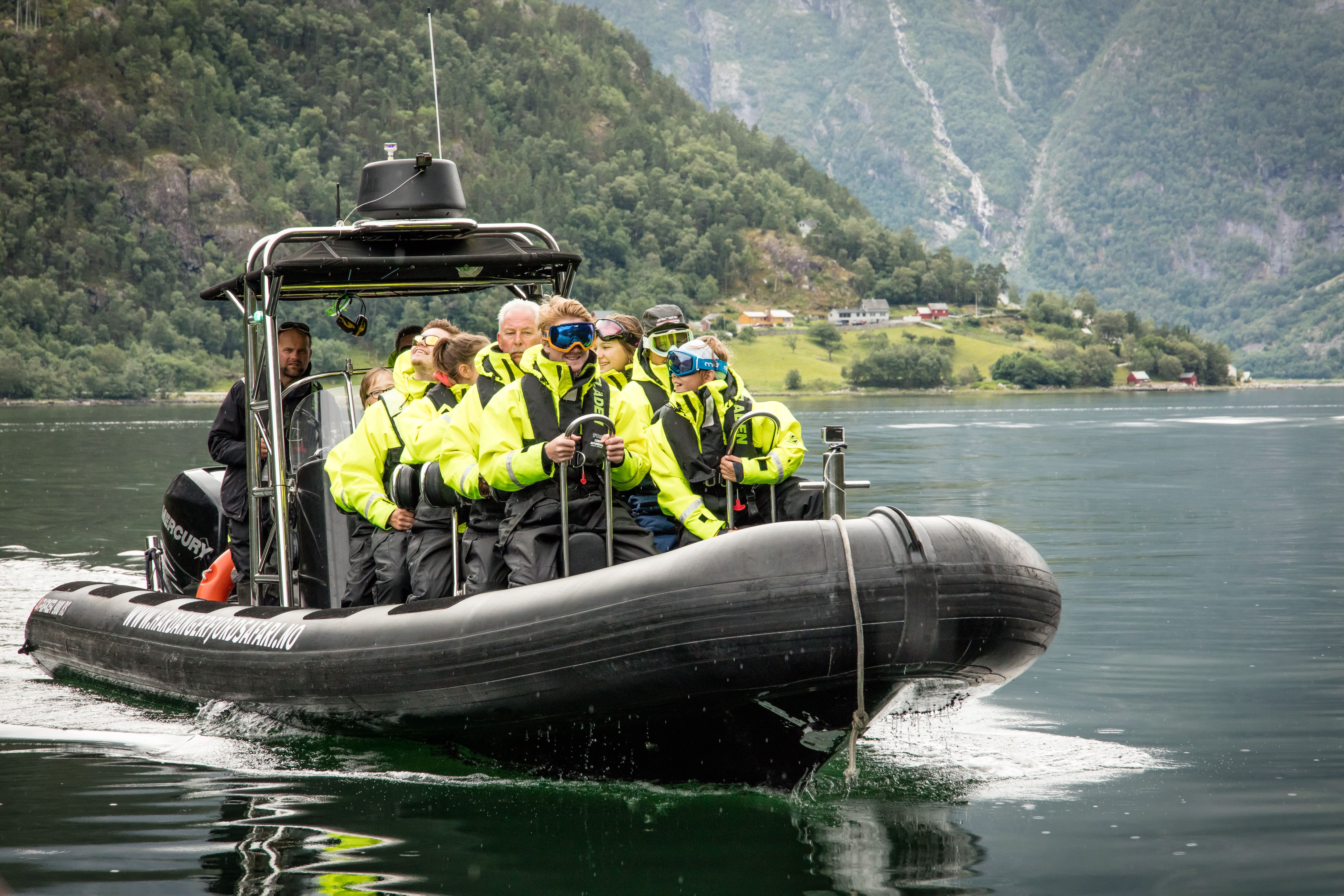 A rib boat filled with passengers, seen from the front.