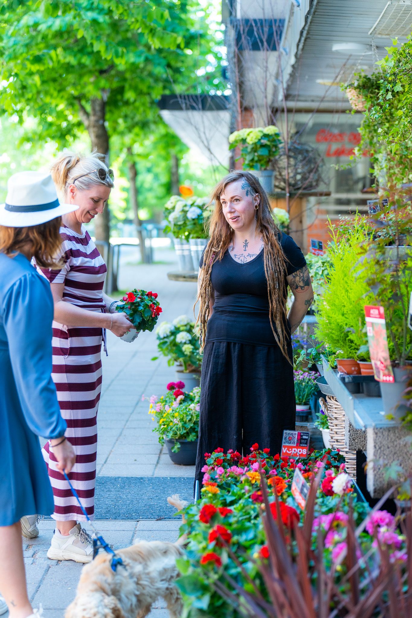 Shop employee in conversation with customers about which plants and what kind of care