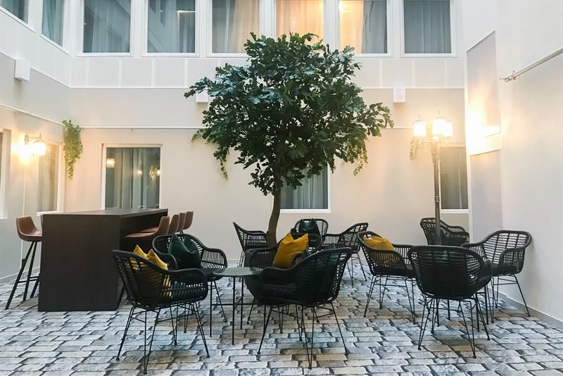 patio with a small trea and seating 