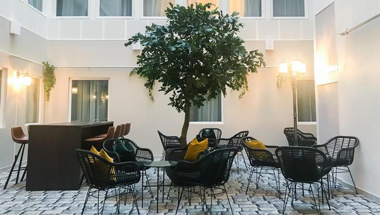 patio with a small trea and seating