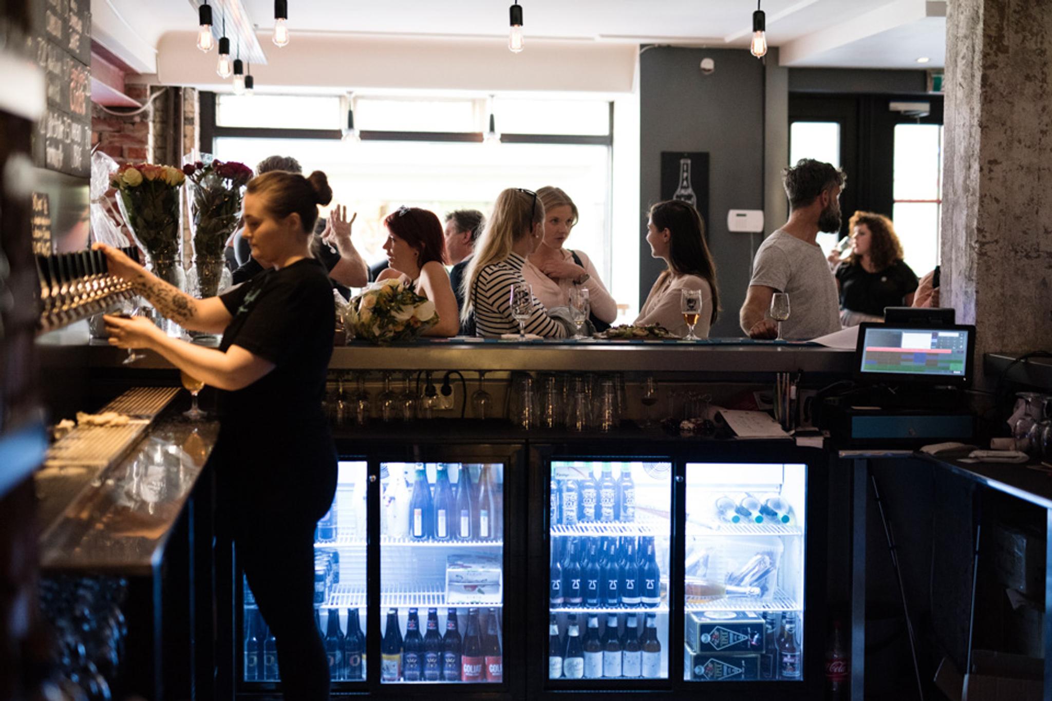 Bar area with lots of people.