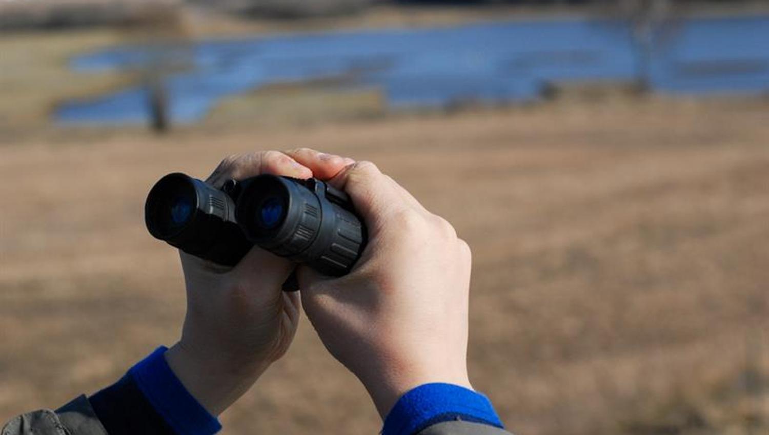 person holding binoculars