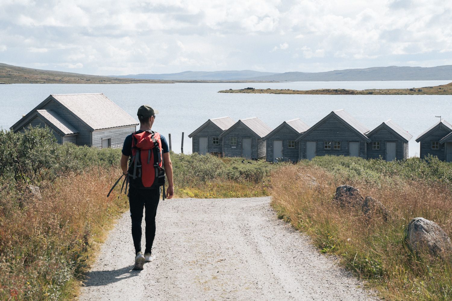 A man walking downhill towards the harbour area at Halne.