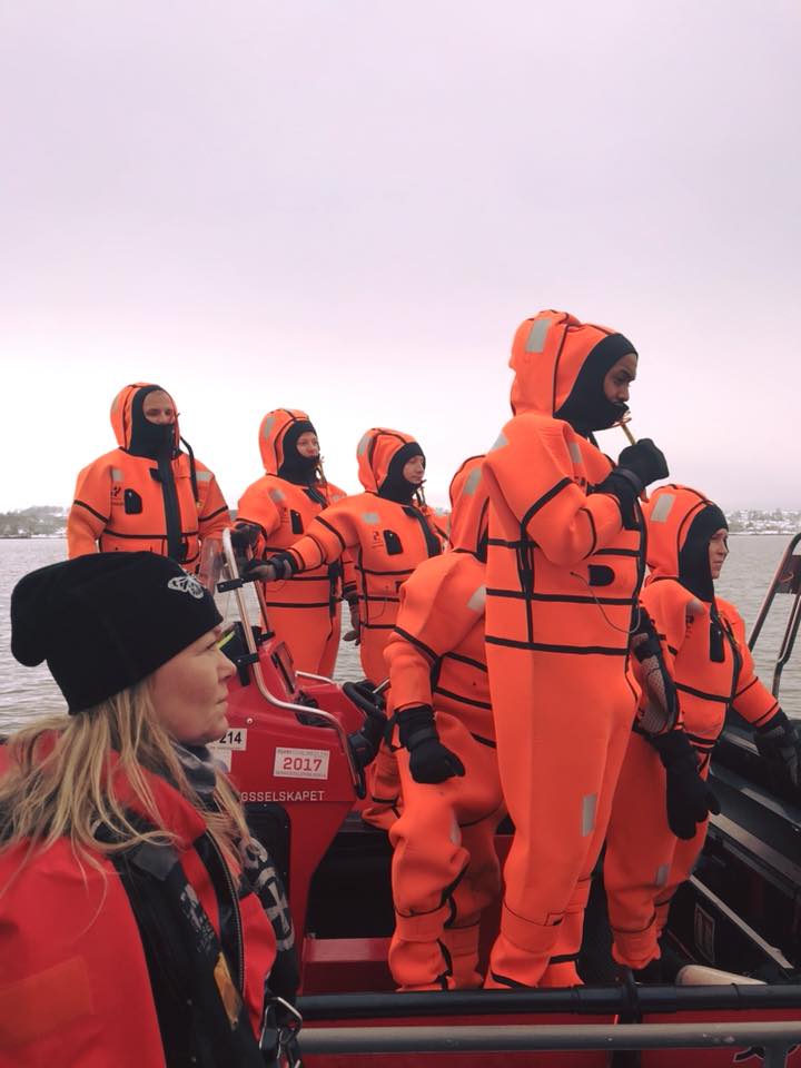 People in orange suits on a boat