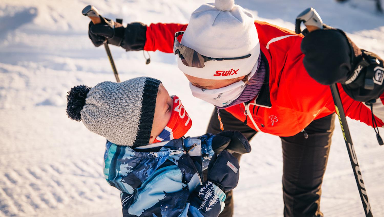 mother and son look at each other happily during the ski trip on Lifjell