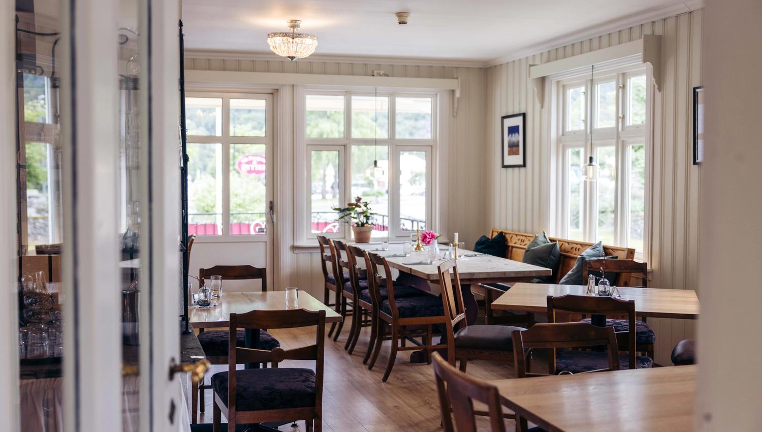 A photo of the restaurant, showing several dining tables and chairs.