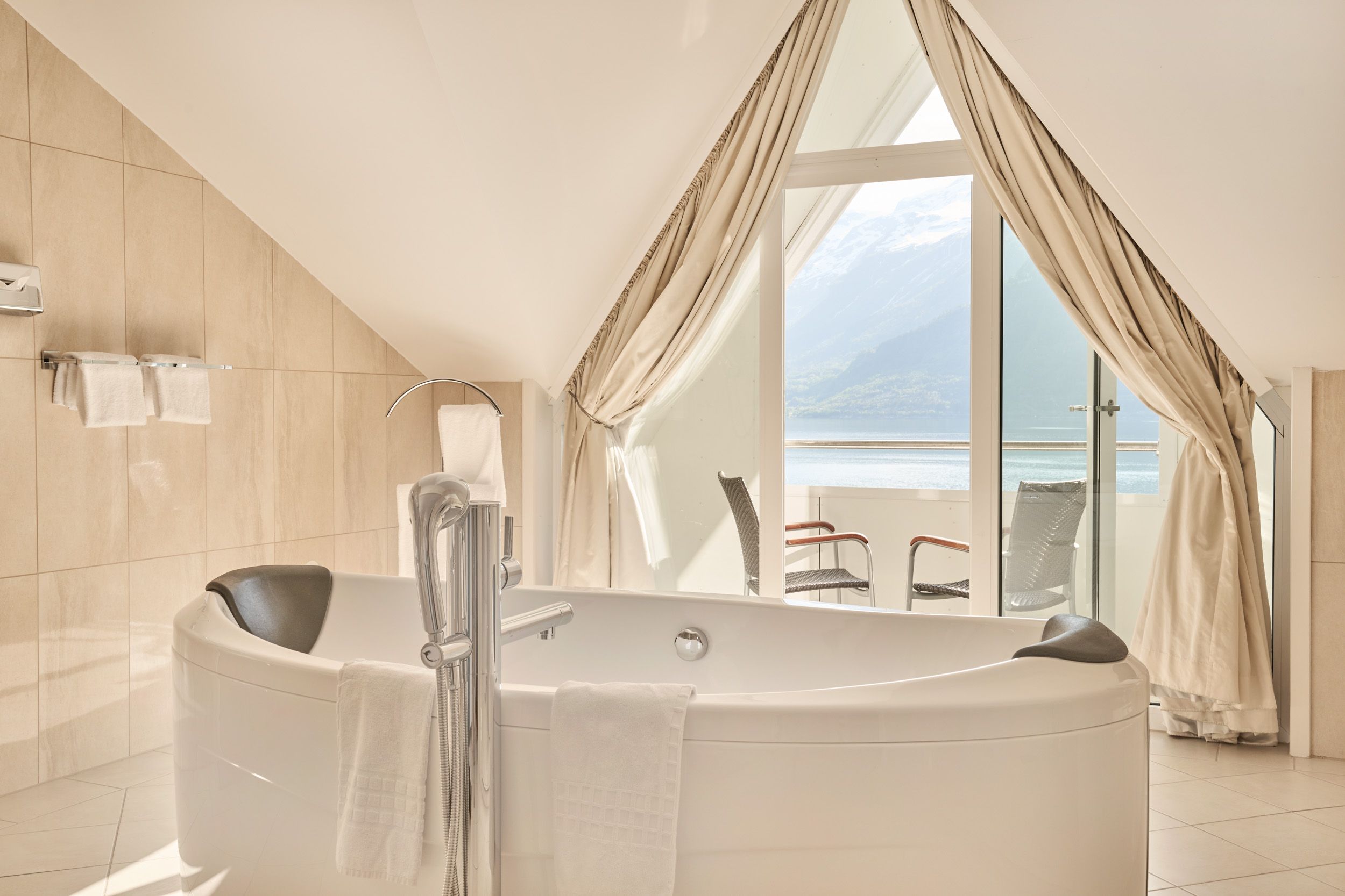 Bright and luxurious bathroom with fjord view at Hotel Ullensvang.