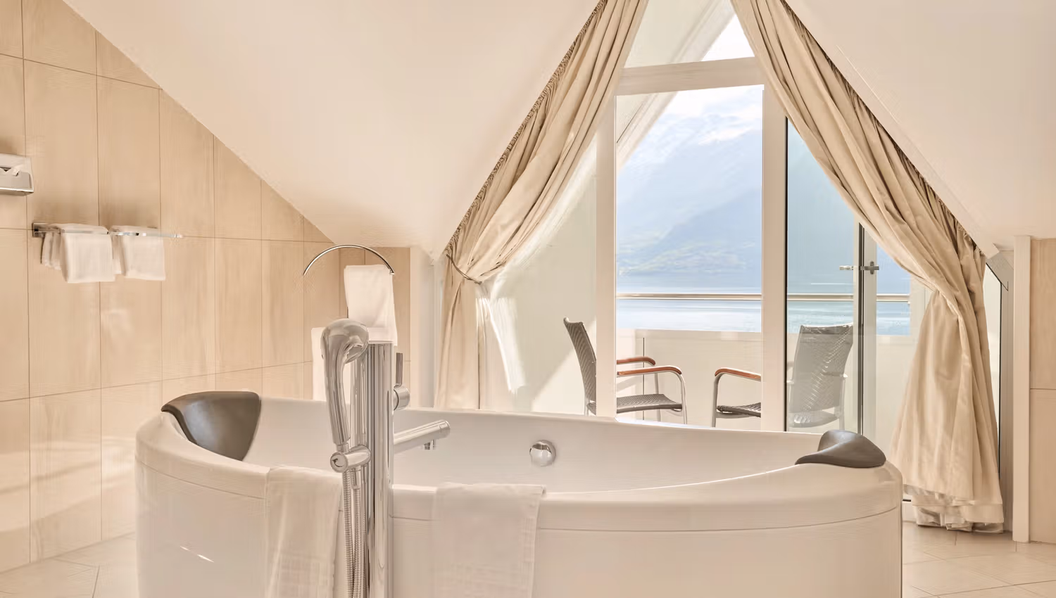 Bright and luxurious bathroom with fjord view at Hotel Ullensvang.