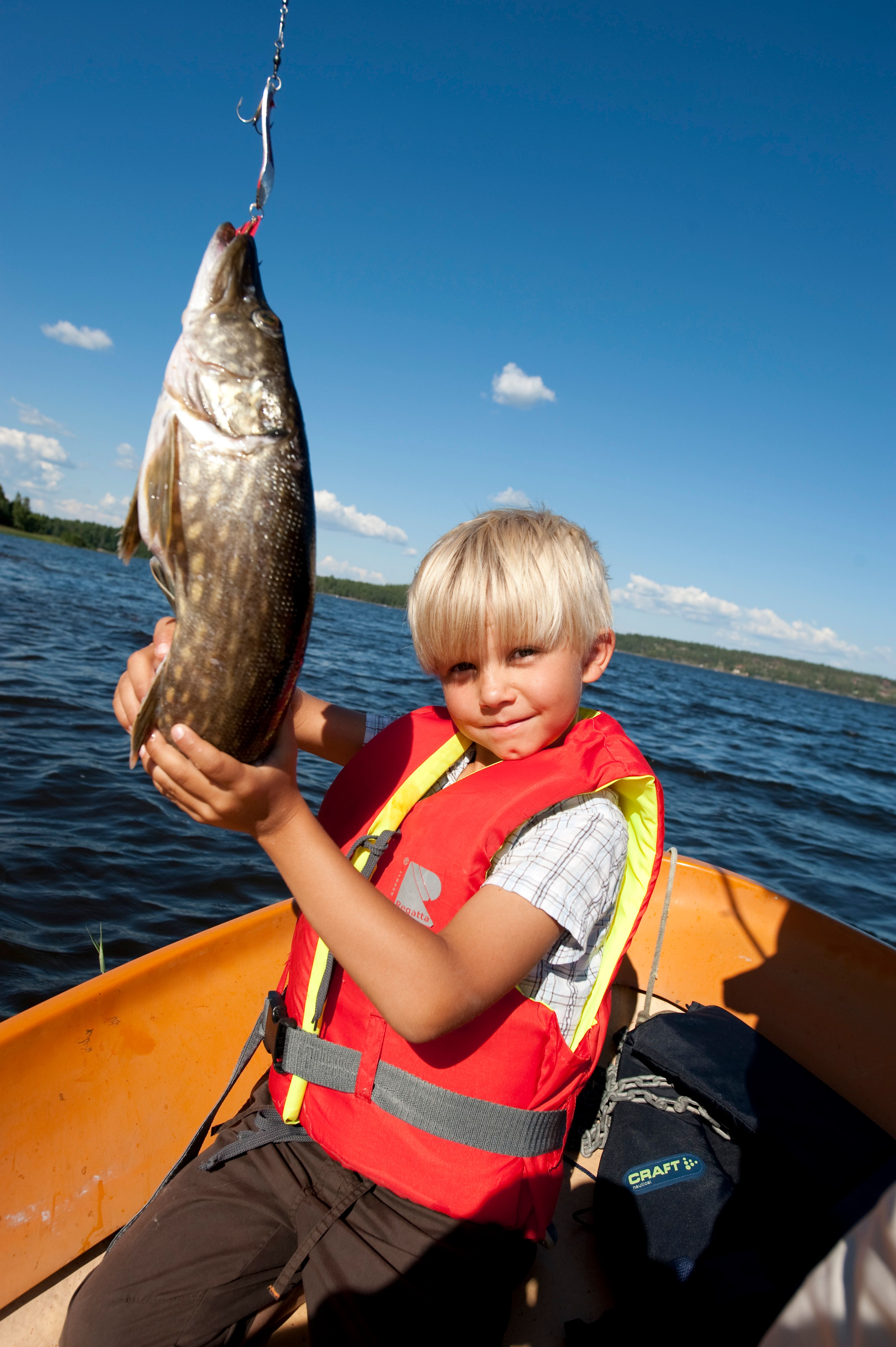 Gutt som holder fisk