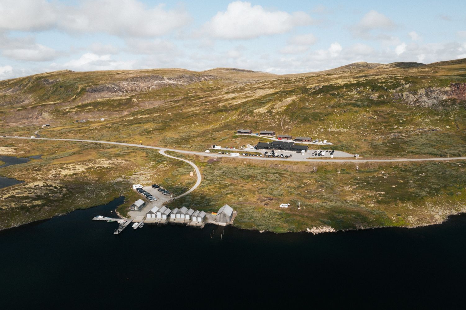 A drone photo of Halne Fjellstugu and the harbour area.