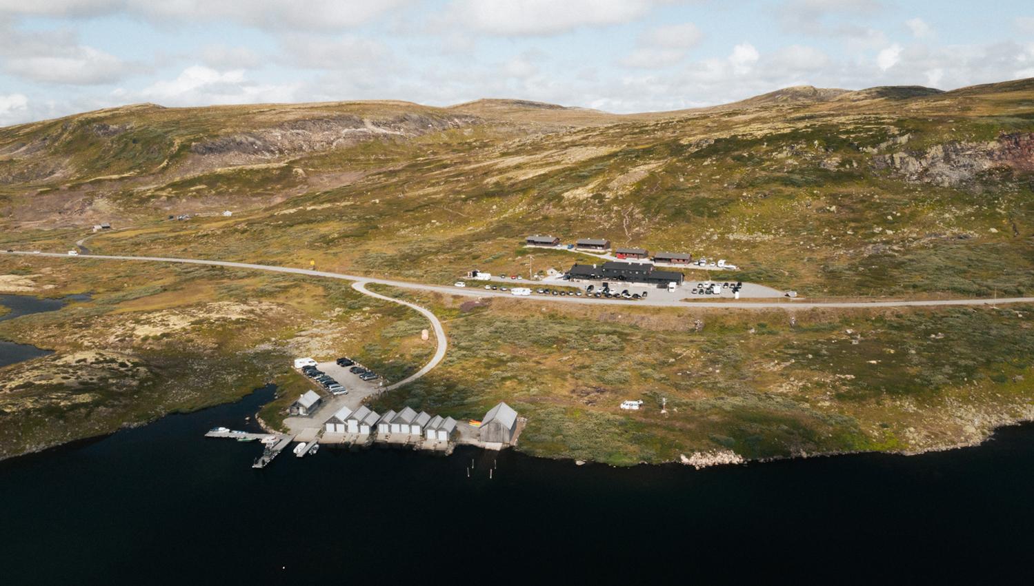 A drone photo of Halne Fjellstugu and the harbour area.