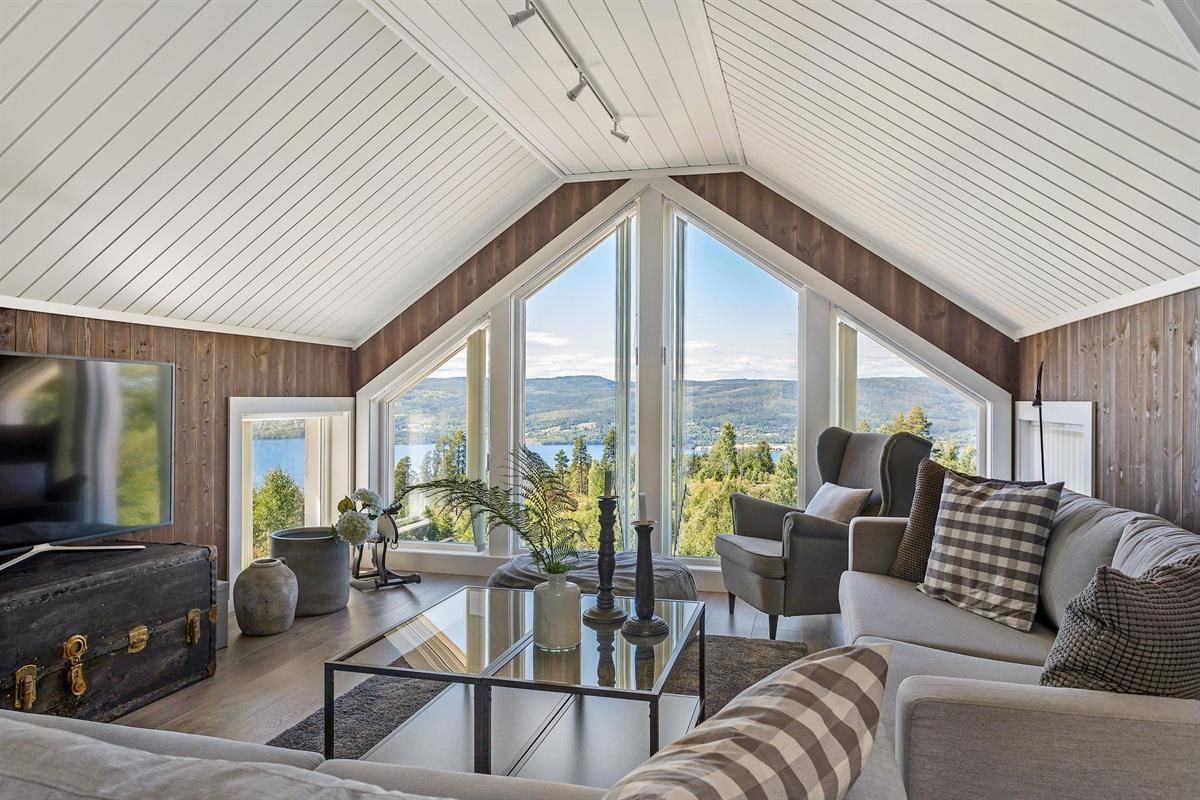  A bright living room with large windows overlooking the landscape.