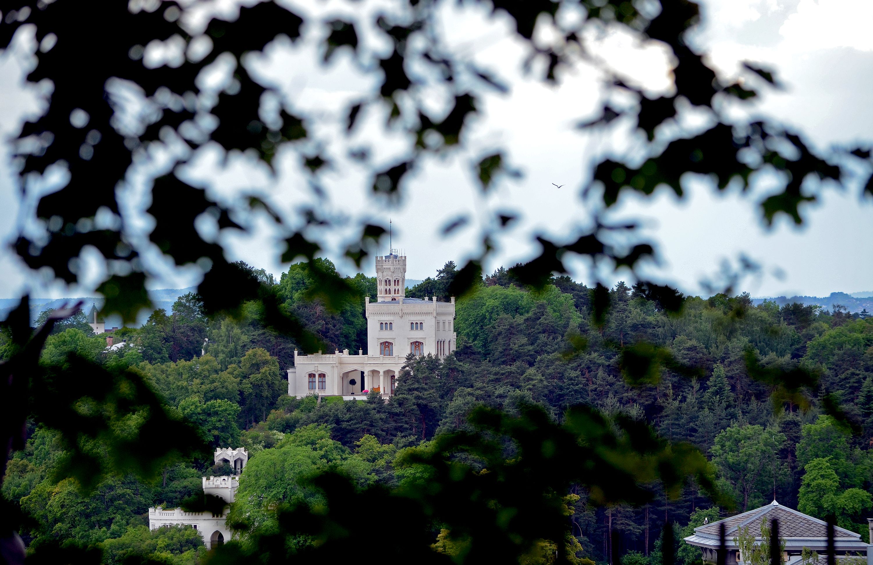 Oscarshall sticking out between the trees on Bygdøy, seen from Frogner borough