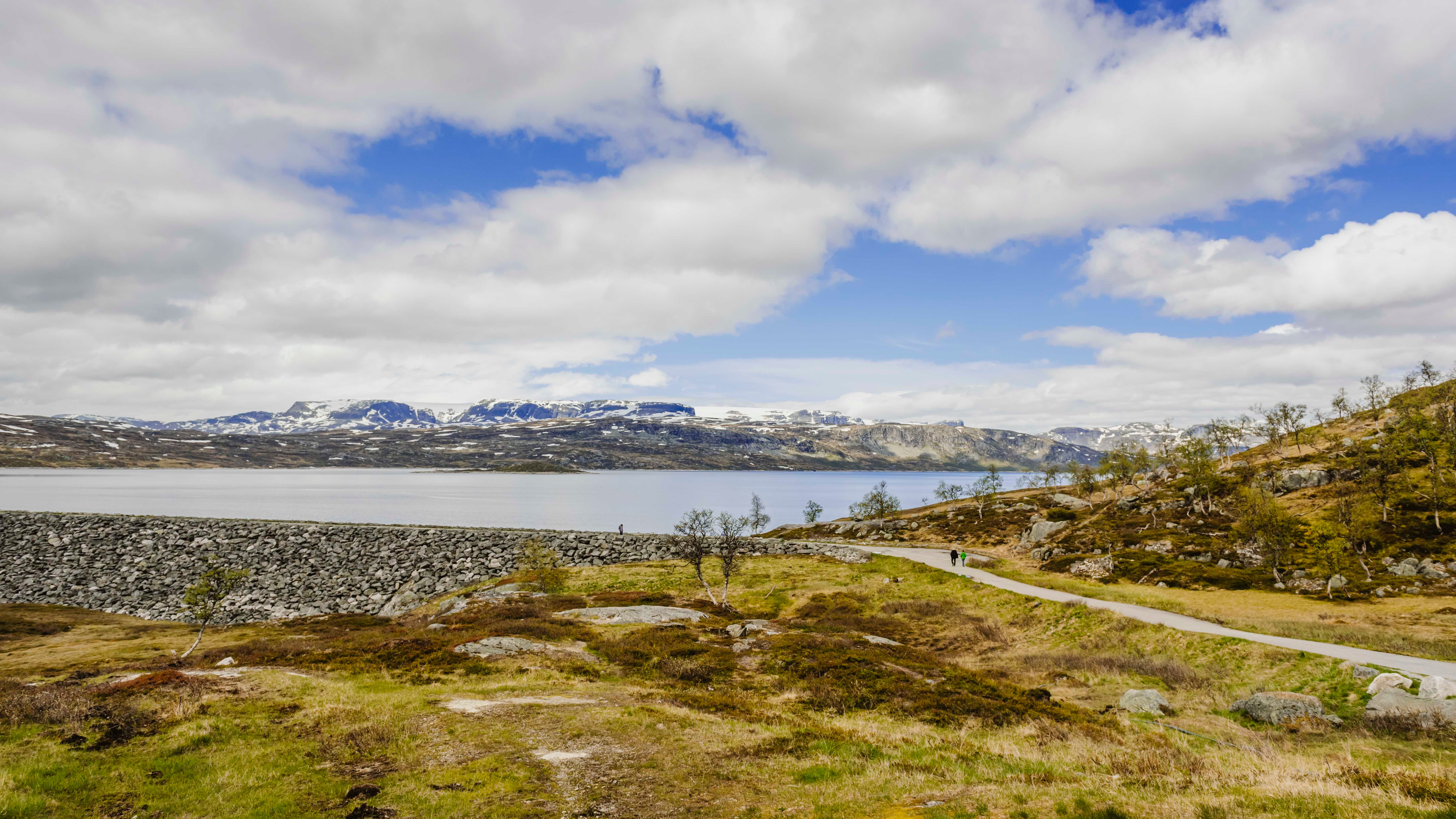 People seen in the distance walking on top of the dam.