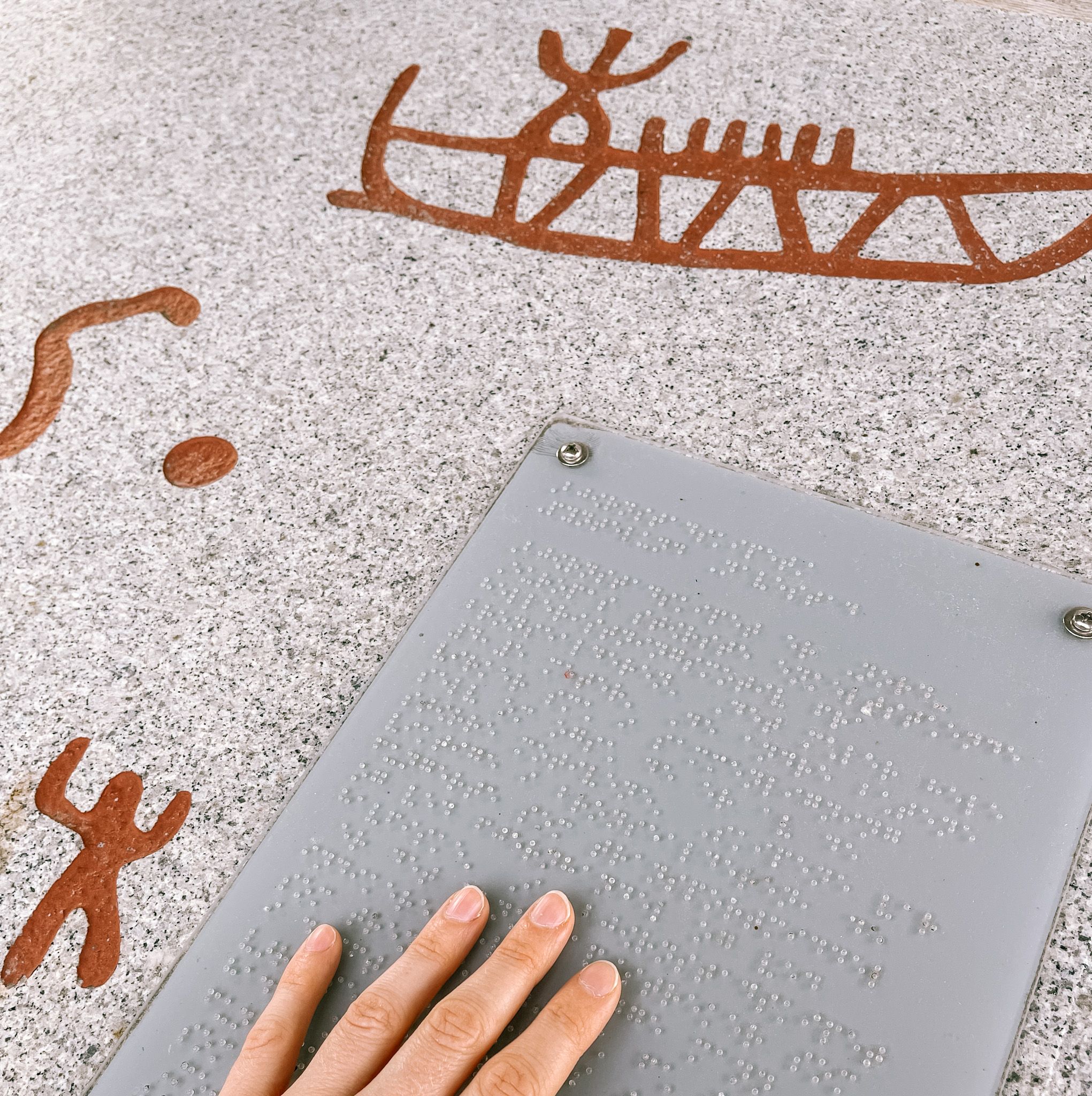 Rock carving exhibition and board with braille at Storedal cultural centre. Photo.