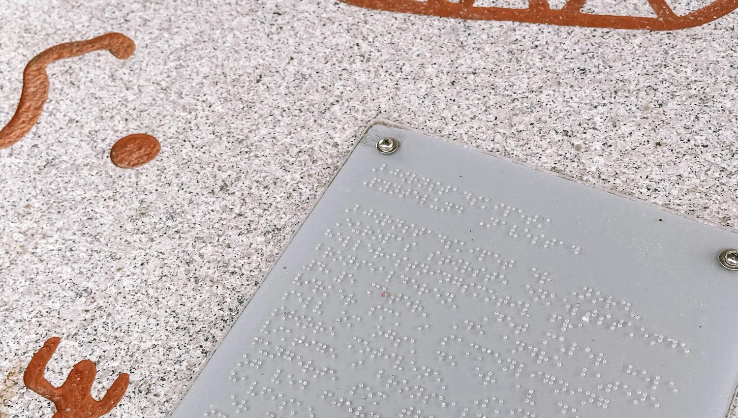 Rock carving exhibition and board with braille at Storedal cultural centre. Photo.
