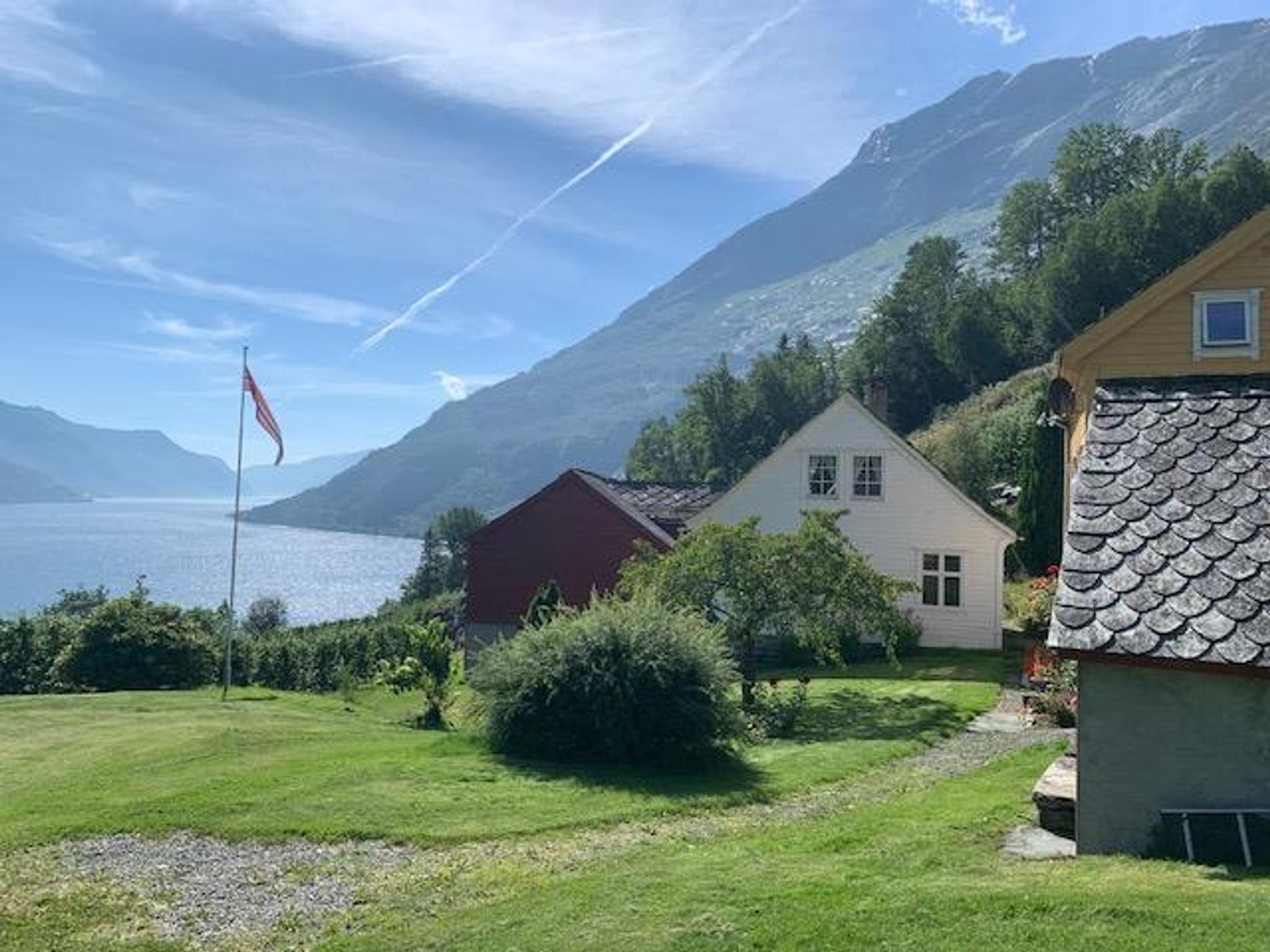 Charming grounds at Jaastad Gjestetun overlooking the Hardangerfjord and majestic mountains.