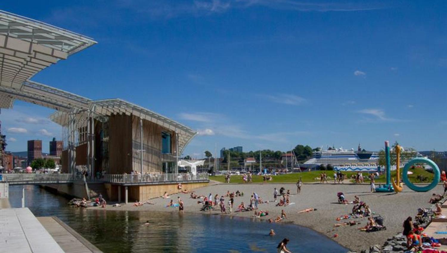 A view of Tjuvholmen beach with people bathing and sunbathing.