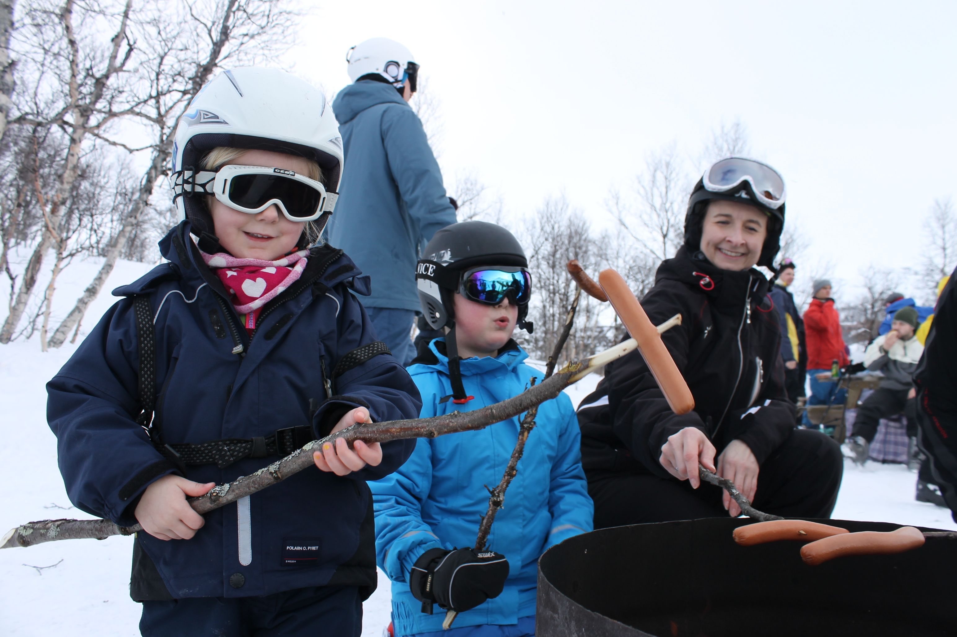 Children grilling sausages at the alpine skiing centre, photo
