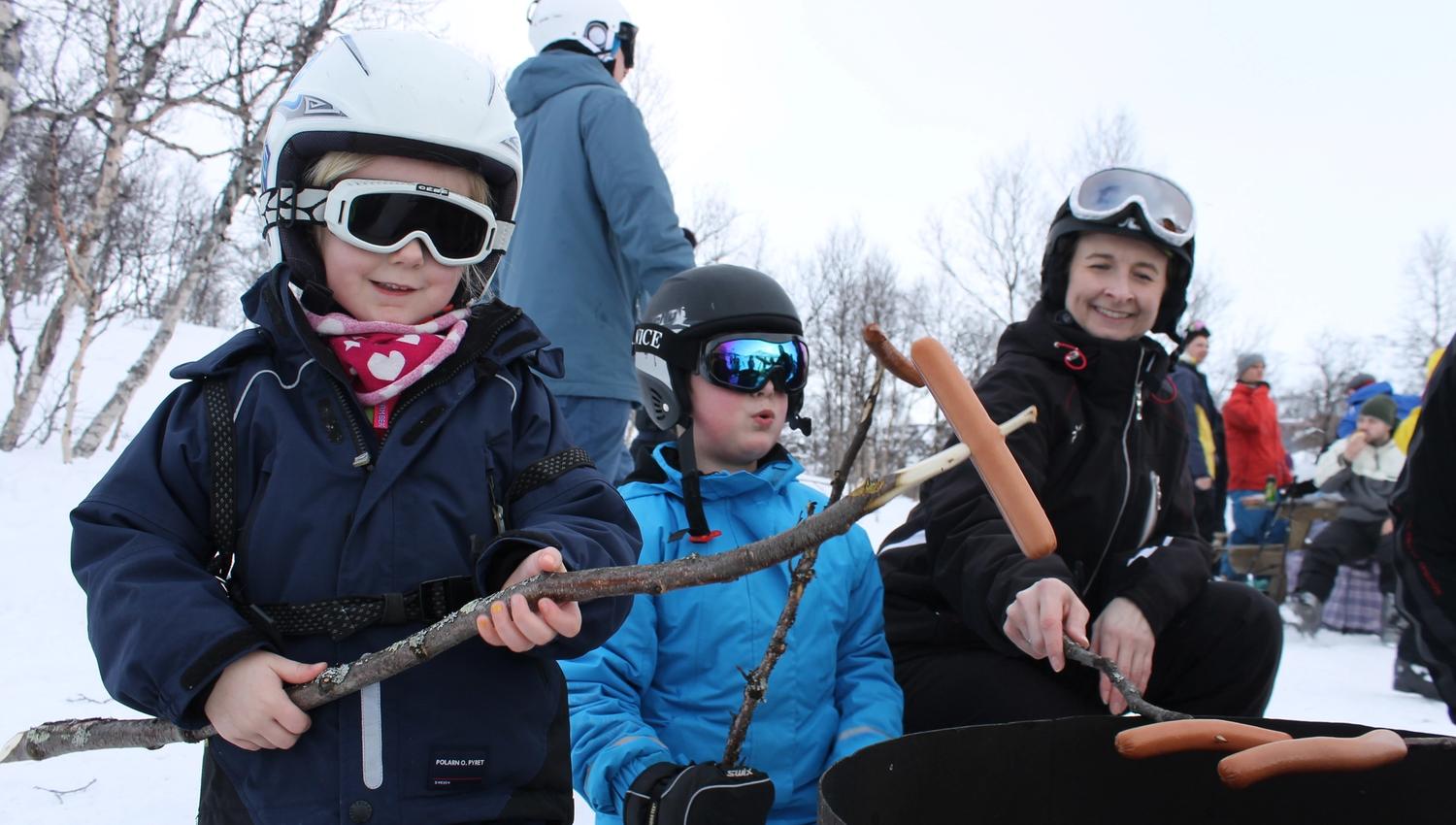Children grilling sausages at the alpine skiing centre, photo