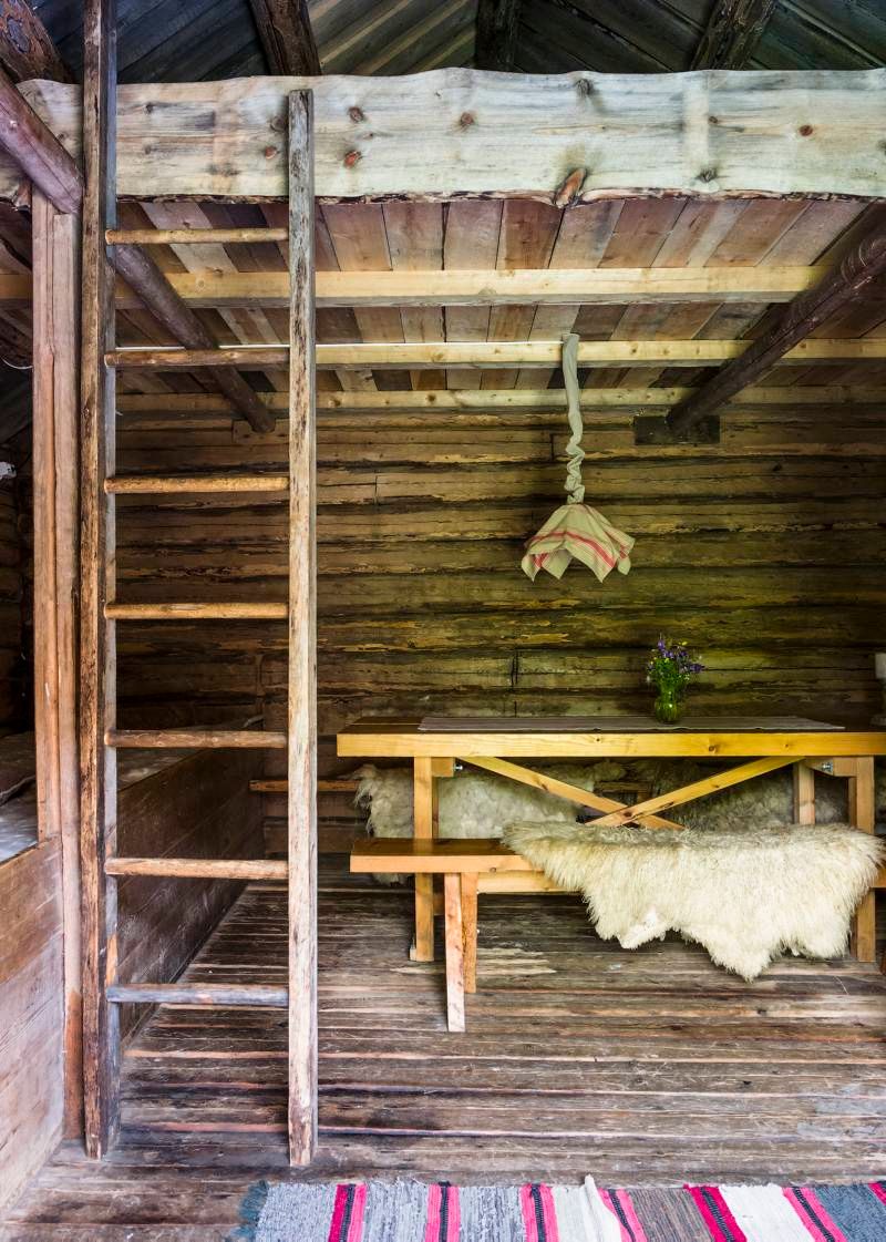 the inside of an old farmershouse with a bench and loft