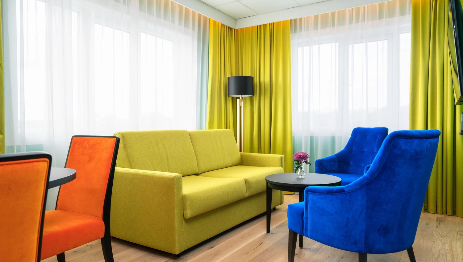bright room with sofa and armchairs