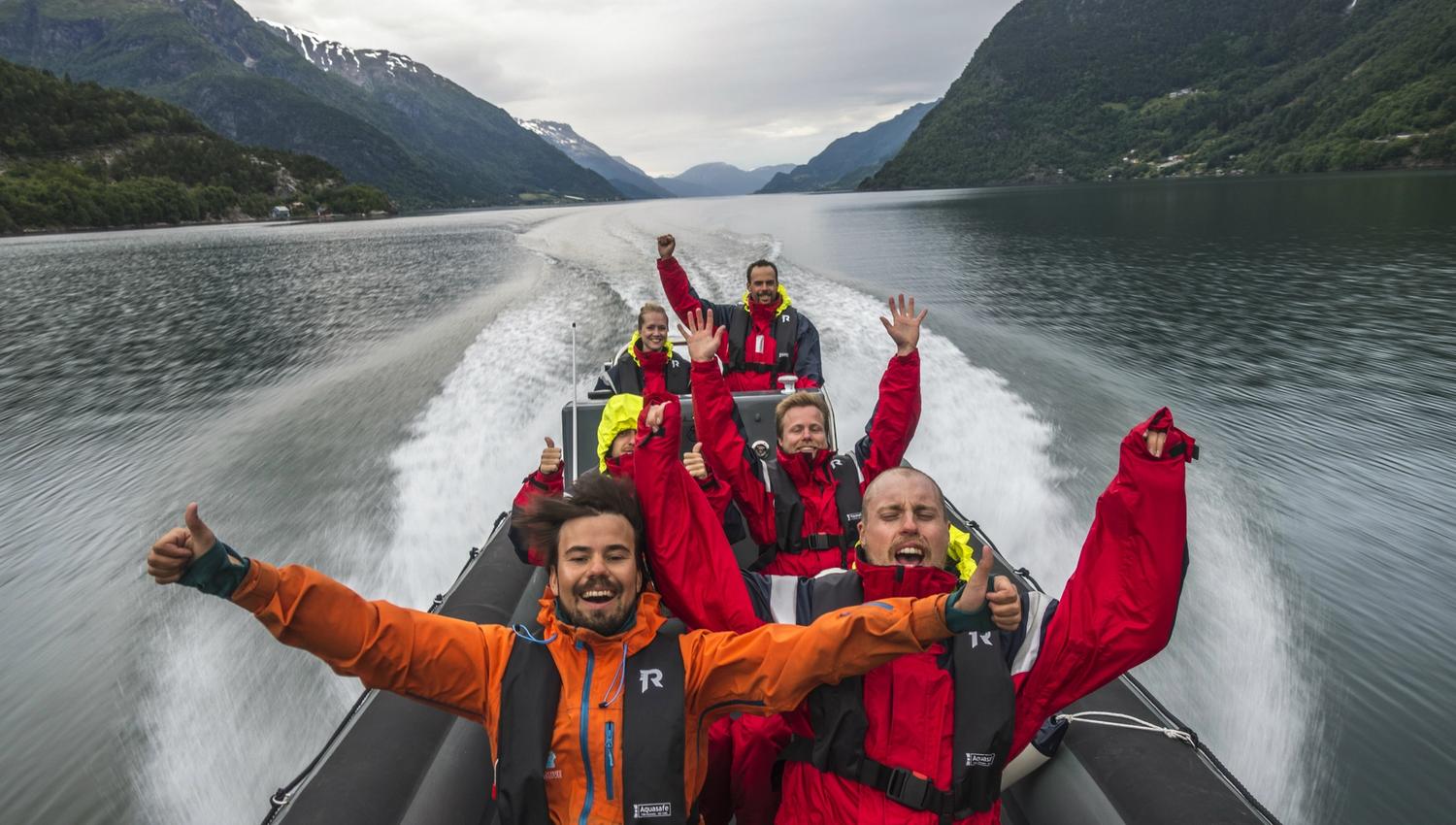 Smilande turistar nyt fartsfylt RIB-safari på Hardangerfjorden.