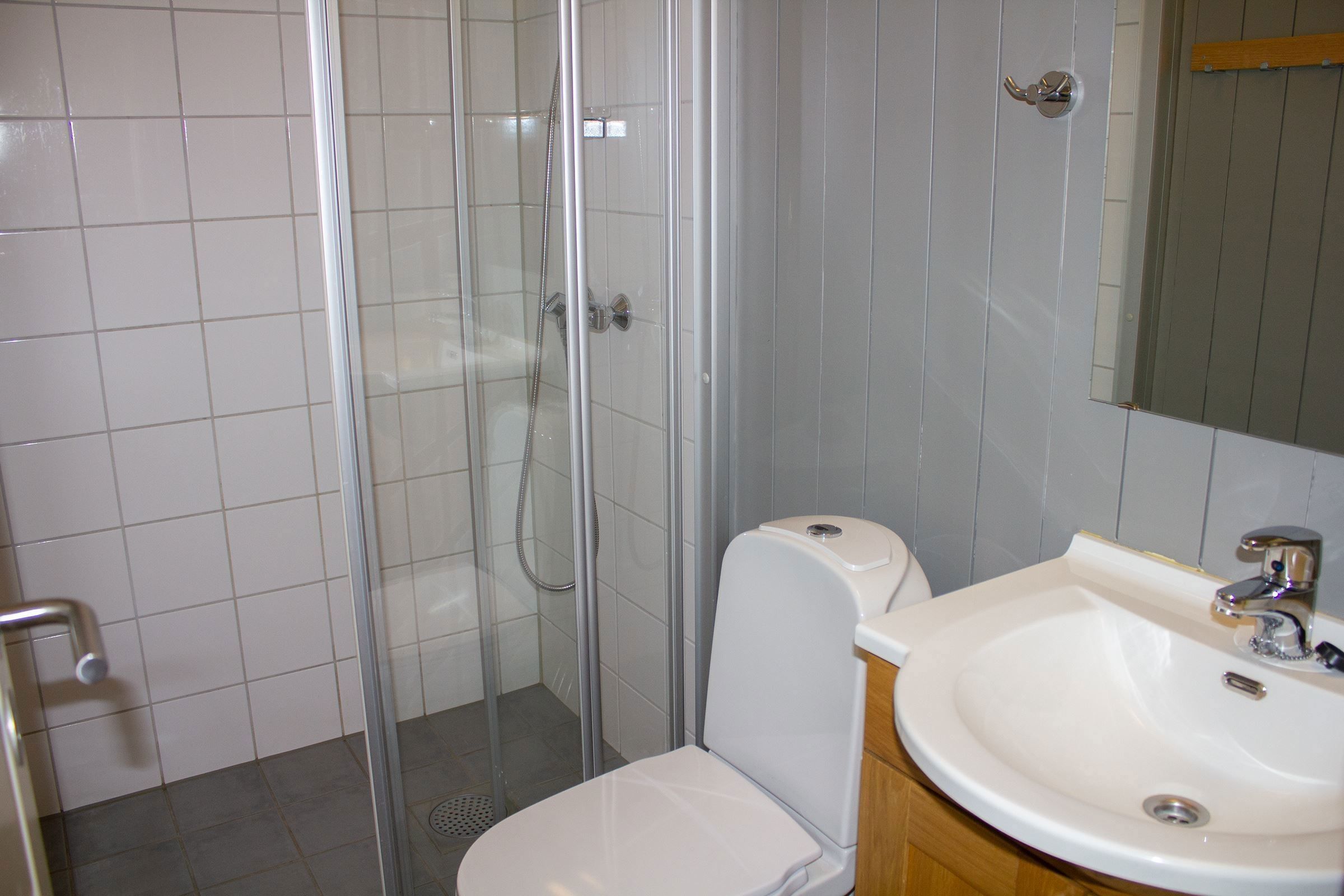 A bathroom with shower and toilet.