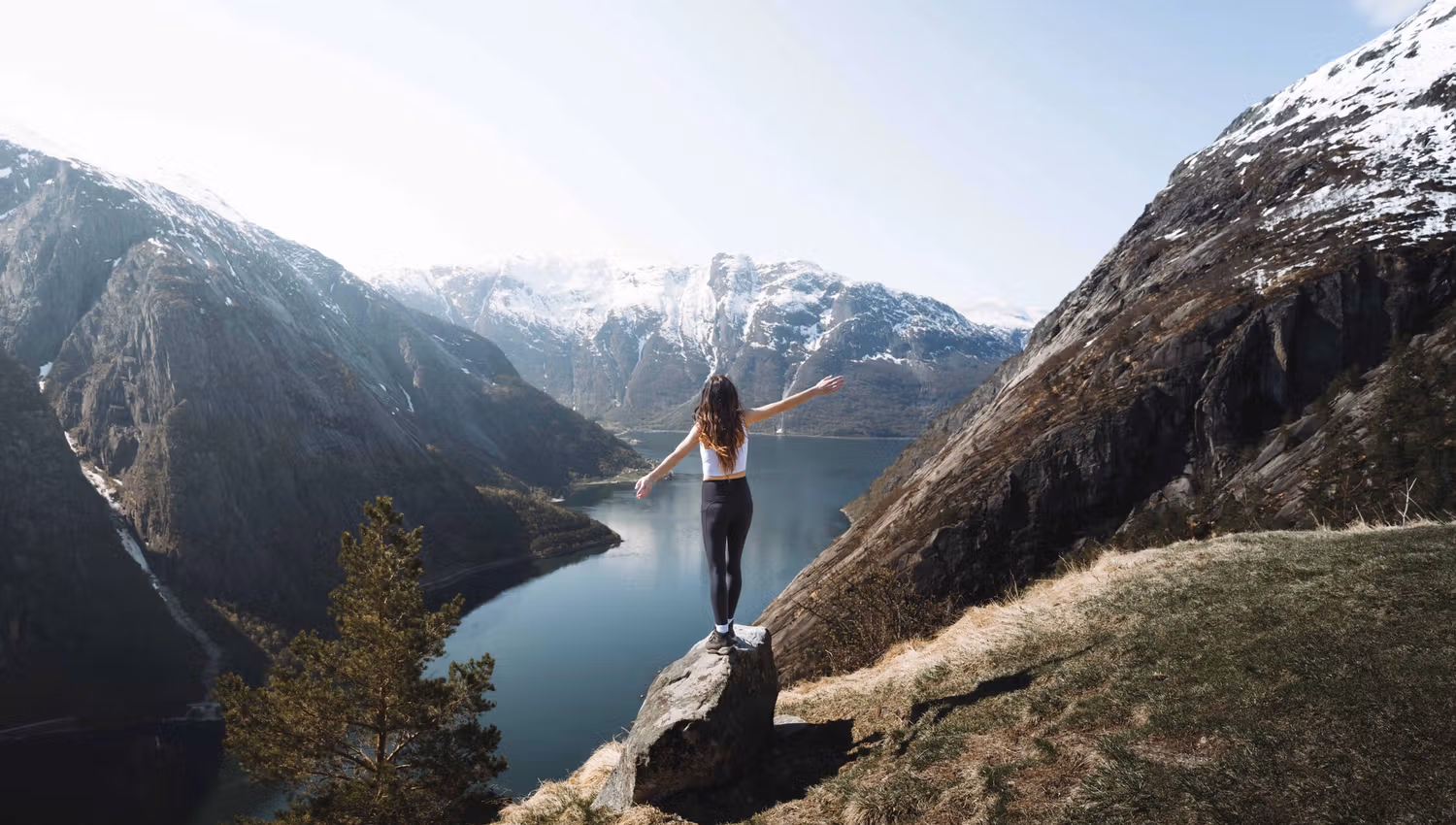 A woman standing on the "selfie rock" at Kjeåsen.