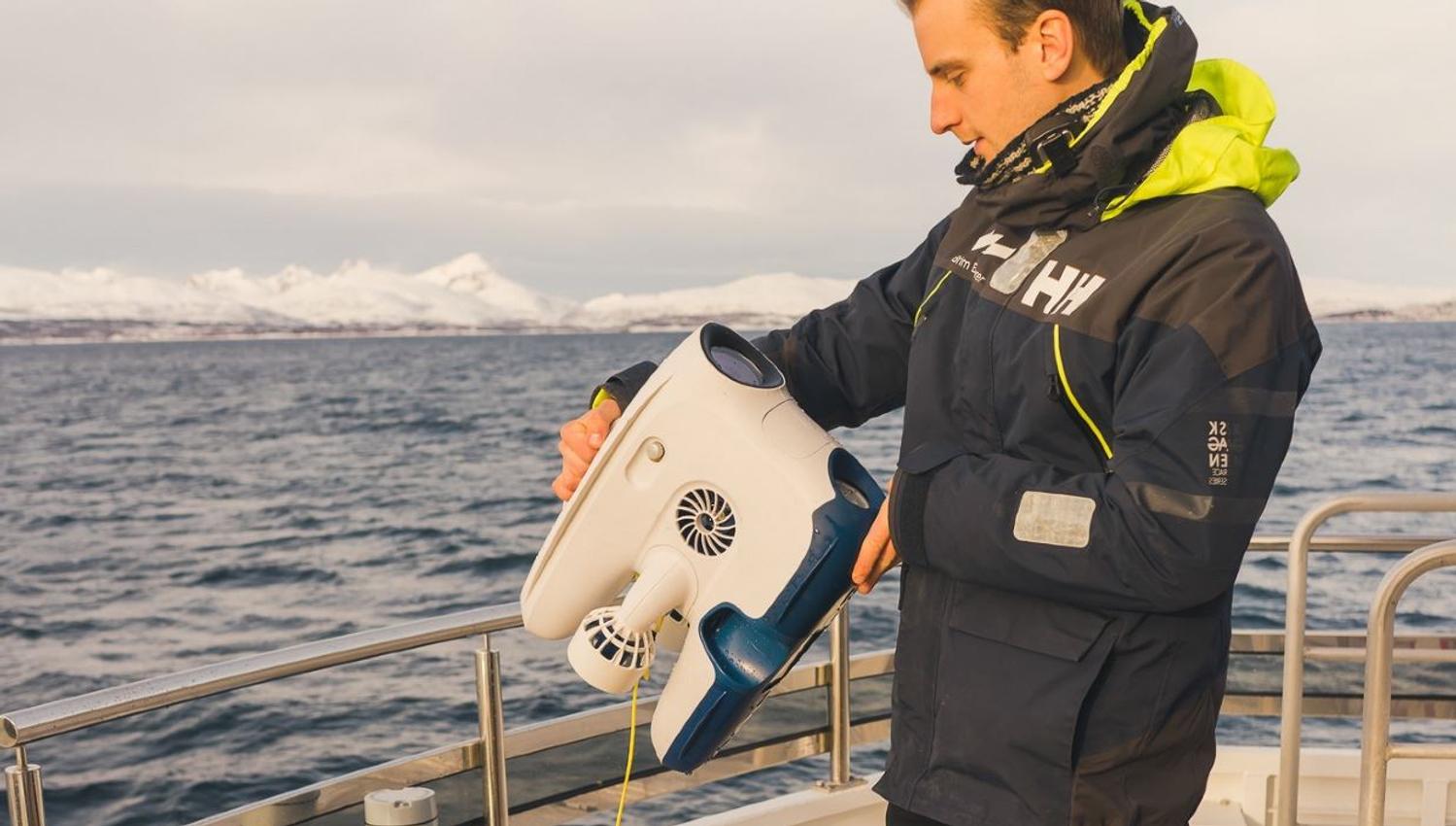 Guide som holder på å gjøre klar undervannsdrone for sjøsetting
