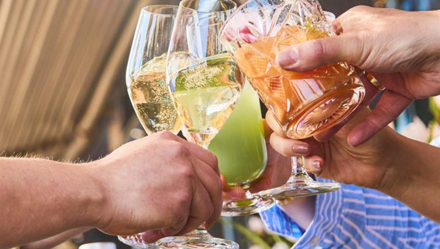 Detail of people toasting.