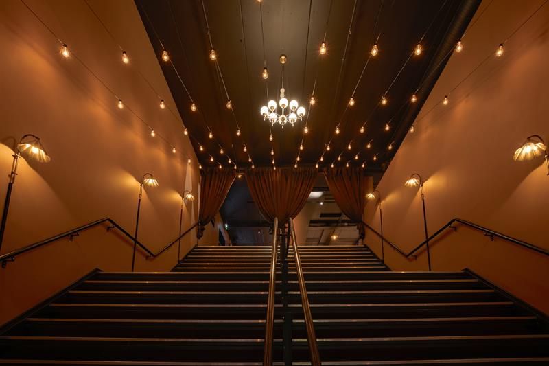 Staircase leading from the entrance area to the bar area.