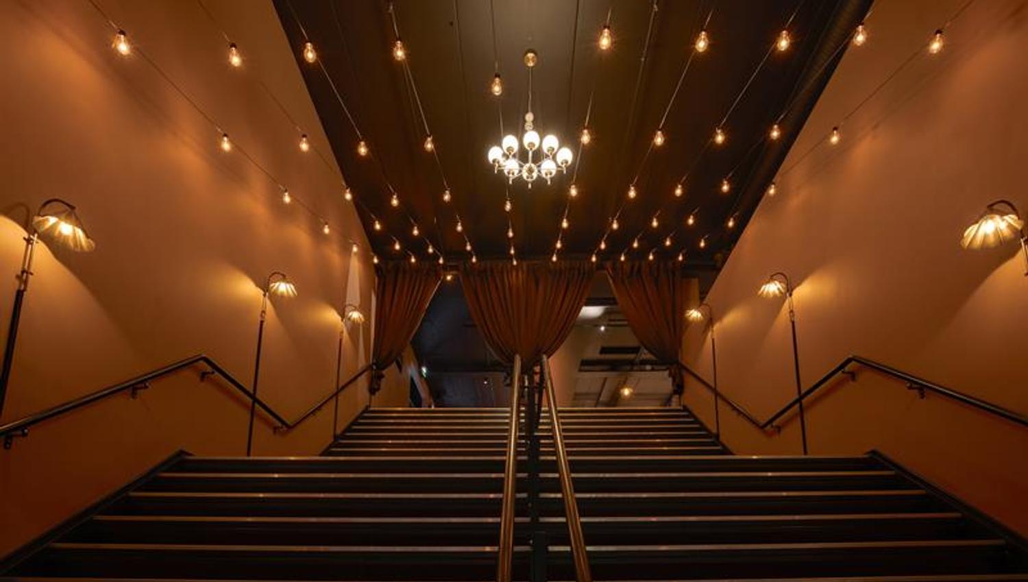 Staircase leading from the entrance area to the bar area.